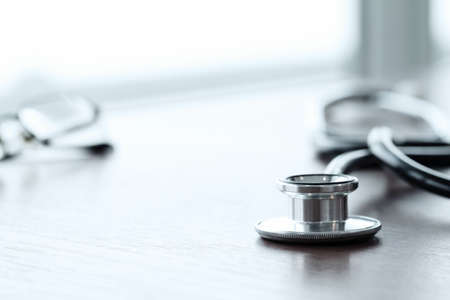 Stethoscope with digital tablet computer on wooden table and  backgroundの写真素材