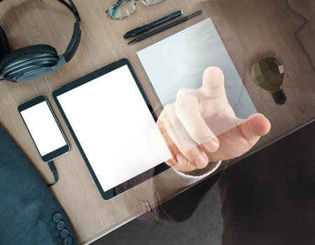 Double exposure of businessman and office desk  and office supplies with blank modern digital tablet...