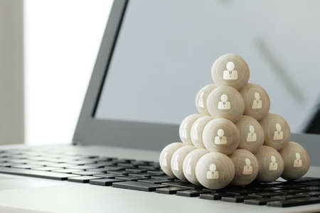 Leadership business concept,people icons on wooden balls on laptop computerの写真素材
