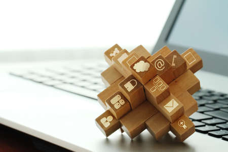 wooden cubes with technology icons on computer as cloud network conceptの写真素材