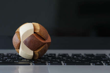 wooden texture globe puzzle on laptop computer as internet conceptの写真素材