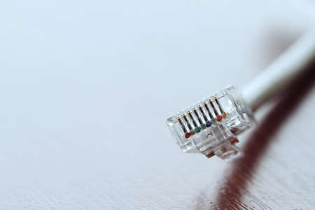 close up of RJ45 Plug Lan Network on wood deskの写真素材