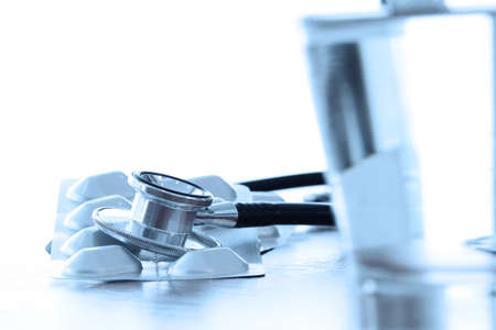 Studio macro of a stethoscope and digital tablet with shallow DOF evenly matched abstract on wood table background copy spaceの写真素材