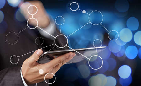 businessman hand showing  blank flow chart on new modern computer as concept with bokeh exposureの写真素材
