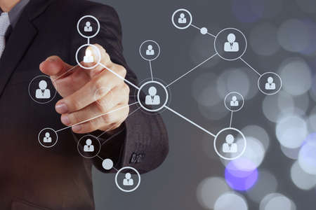 businessman hand showing human icon flow chart on new modern computer as concept with bokeh exposureの写真素材