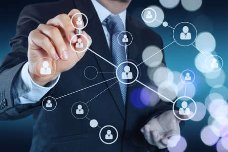 businessman hand showing human icon flow chart on new modern computer as concept with bokeh exposureの写真素材