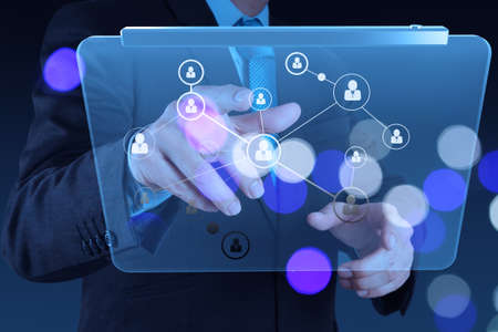 businessman hand showing human icon flow chart on new modern computer as concept with bokeh exposureの写真素材