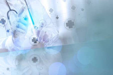 Medicine doctor hand working with modern computer interface as medical conceptの写真素材