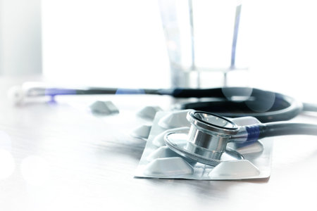 Studio macro of a stethoscope and pillsの写真素材