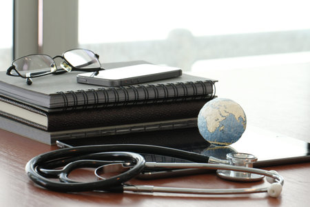 Studio macro of a stethoscope and texture globe 