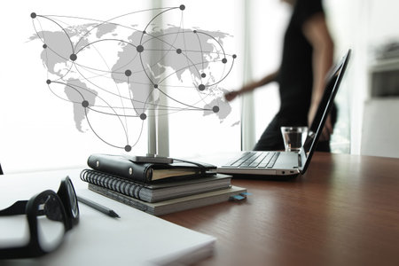 Young creative designer man working at office and social network media diagram as concept