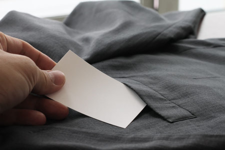 Blank corporate identity package business card with dark grey suit background.