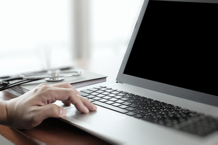 close up of Doctor hand using laptop computer in officeの写真素材