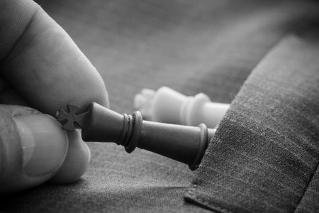 close up of chess figure on suit background strategy or leadership concept