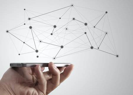Hand holding mobile phone with social media diagram network- Concept of communication in the network