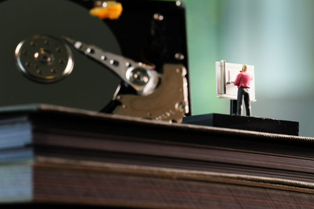 Big data concept-miniature engineer working wirh drafting table with open harddisk background