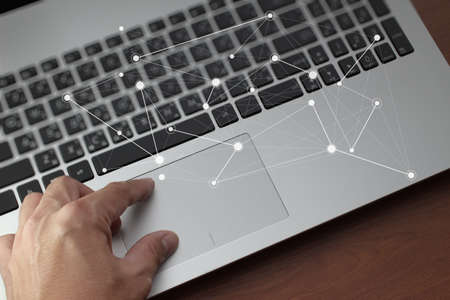 Close up of business man working on laptop computer with social media diagram as conceptの写真素材