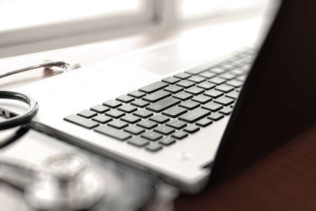 Doctor working with laptop computer in medical workspace office as conceptの写真素材