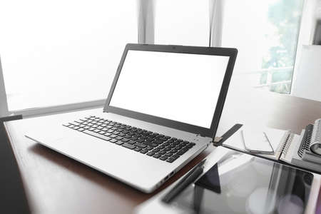 Office workplace with  blank screen  laptop and smartphone on wood tableの写真素材