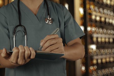 Traditional doctor working with blurred vintage bottle with bokeh background as vintage old school conceptの写真素材