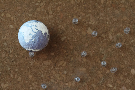hand drawn texture globe and social network diagram with pin on cork board as conceptの写真素材