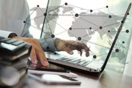 business documents on office table with digital tablet and man working with smart laptop computer...