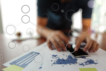 Young creative designer man working at office and social network media diagram as concept