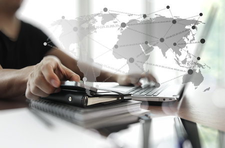 business documents on office table with digital tablet and man working with smart phone in the...