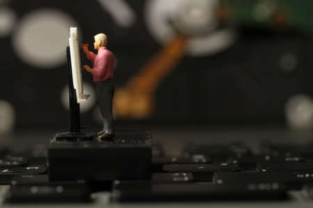 Big data concept-miniature engineer working with drafting table with open hard disk backgroundの写真素材