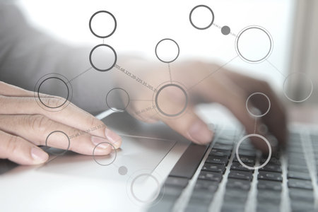 Close up of business man hand working on laptop computer with social media diagram and chart graph...