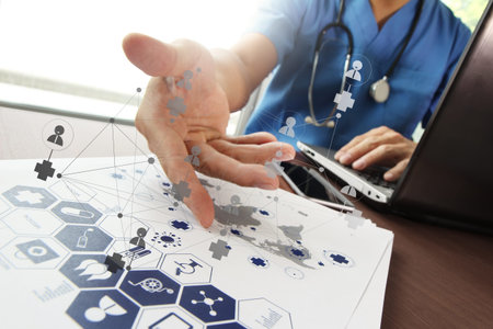 Doctor working with  laptop computer in medical workspace office and medical network media diagram...