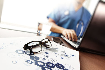 Doctor working with  laptop computer in medical workspace office and medical network media diagram...