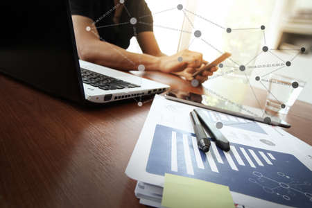 Young creative designer man working at office and social network media and graph chart diagram as conceptの写真素材