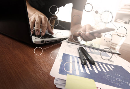 business documents on office table with smart phone and digital tablet and graph business diagram...