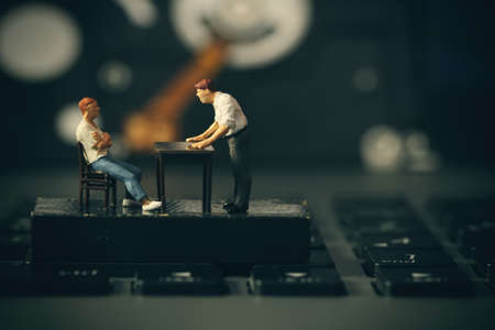 working online concept-miniature businessman boss angry with employee on laptop computerの写真素材