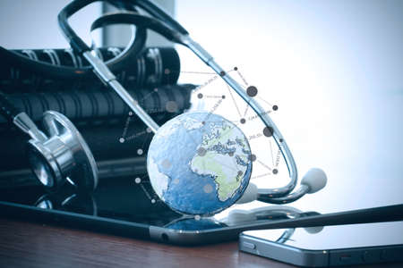 Studio macro of a stethoscope and texture globe with digital tablet with shallow DOF evenly matched abstract as medical network conceptの写真素材