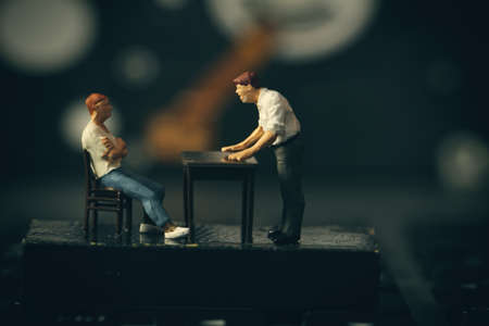 working online concept-miniature businessman boss angry with employee on laptop computerの写真素材