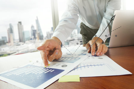 business documents on office table with smart phone and digital tablet and graph business diagram...