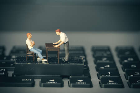 working online concept-miniature businessman boss angry with employee on laptop computerの写真素材