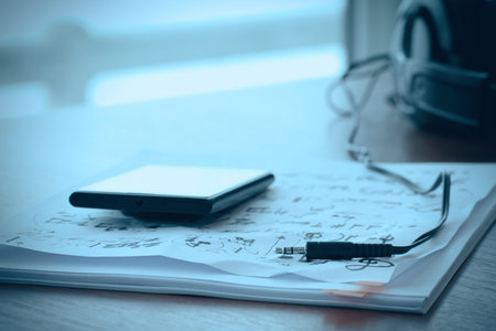 composing music concept with shallow DOF evenly matched jack of headphone and crumpled musical notes paperの写真素材
