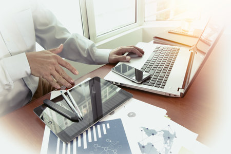 business documents on office table with smart phone and digital tablet and graph business diagram...