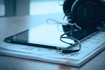 composing music concept with shallow DOF evenly matched jack of headphone and crumpled musical notes paperの写真素材