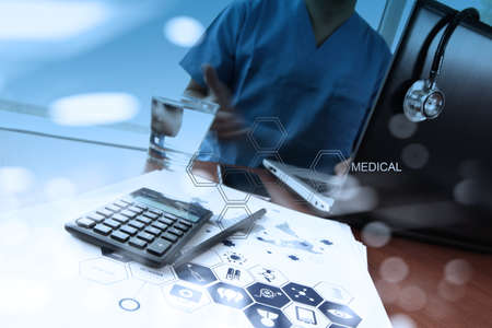 double exposure of doctor working with digital tablet and laptop computer in medical workspace office and medical network media diagram as conceptの写真素材