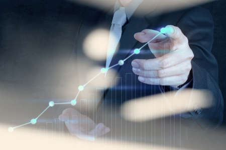 Double exposure of businessman hand working with new modern computer and business strategy as conceptの写真素材
