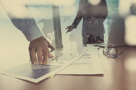Double exposure of businessman hand working with new modern computer and business strategy as conceptの写真素材