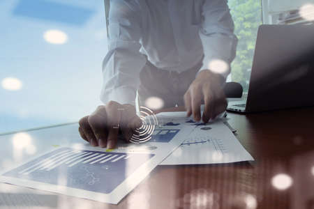 Double exposure of businessman hand working with new modern computer and business strategy as conceptの写真素材