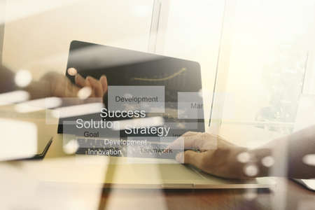 double exposure of new modern laptop computer with businessman hand working and business strategy as conceptの写真素材