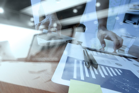 business documents on office table with smart phone and digital tablet and graph business diagram...