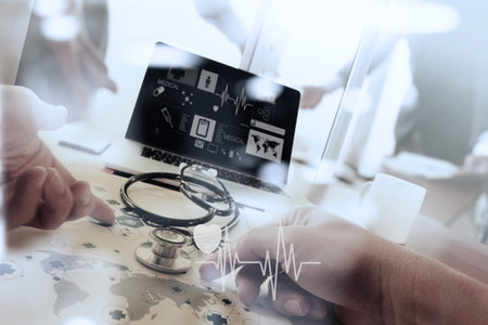 Doctor working with digital tablet and laptop computer in medical workspace office and medical...