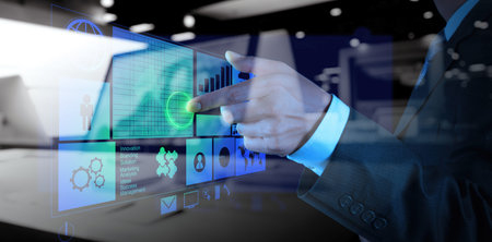 double exposure of businessman hand working with new modern computer and business strategy as...